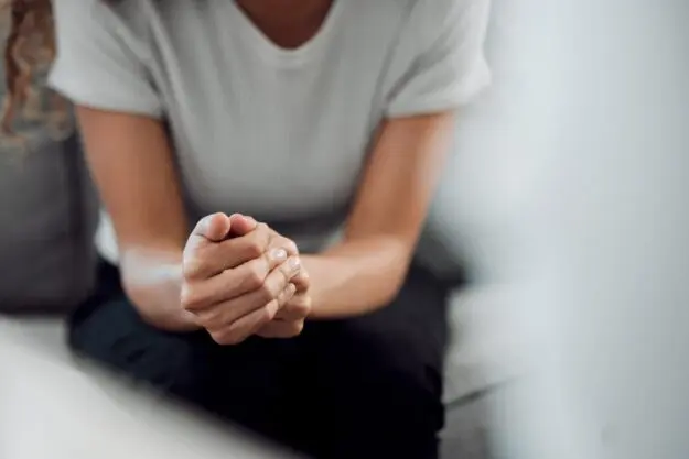 How Do I Know What Mental Health Therapies are Right for Me_ a person looks nervous folding their hands and learning about the types of mental health therapy