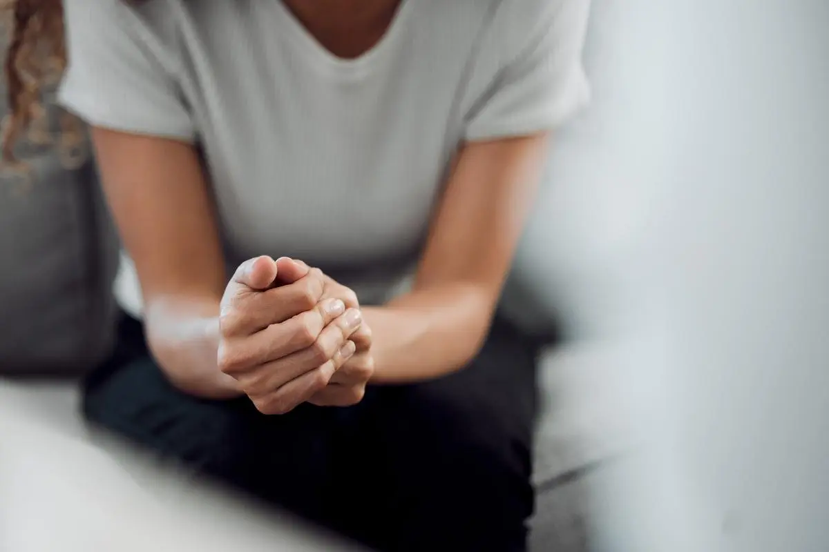 How Do I Know What Mental Health Therapies are Right for Me_ a person looks nervous folding their hands and learning about the types of mental health therapy