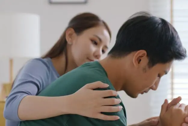 What Mental Health Conditions Can REBT Treat_ a person comforts someone who looks stressed and tells them about rebt and depression