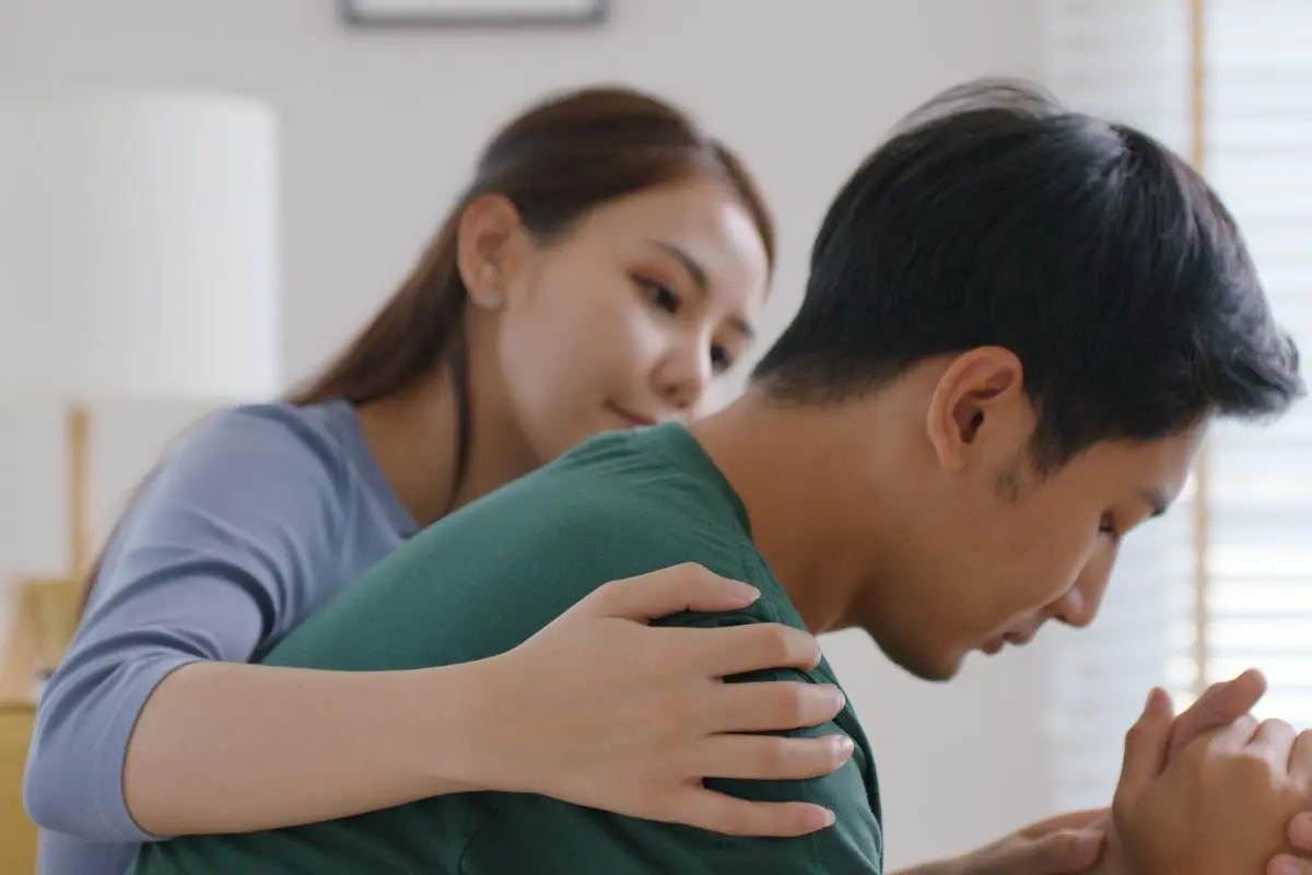 What Mental Health Conditions Can REBT Treat_ a person comforts someone who looks stressed and tells them about rebt and depression