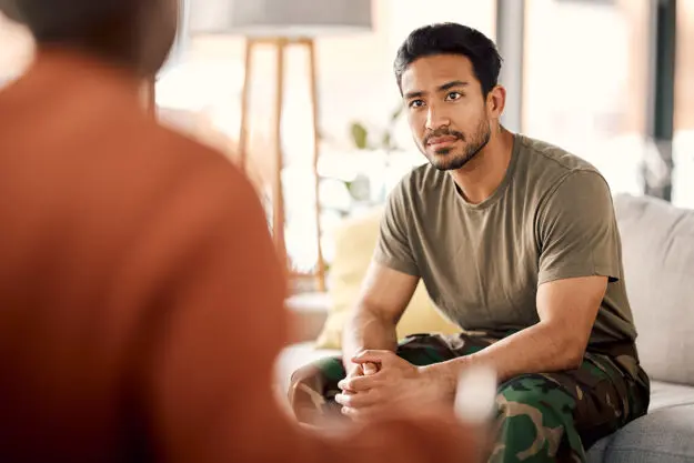 Military PTSD Treatment Center in Florida a veteran talks to a therapist in a military ptsd treatment centers