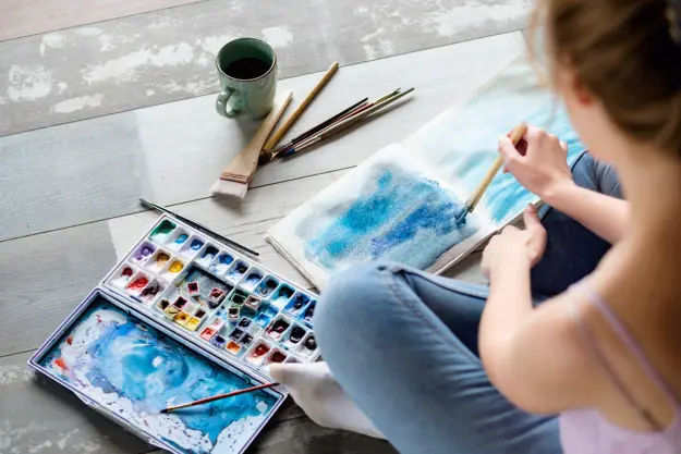 6-Art-Therapy-Activities a woman does watercolors in her art therapy program