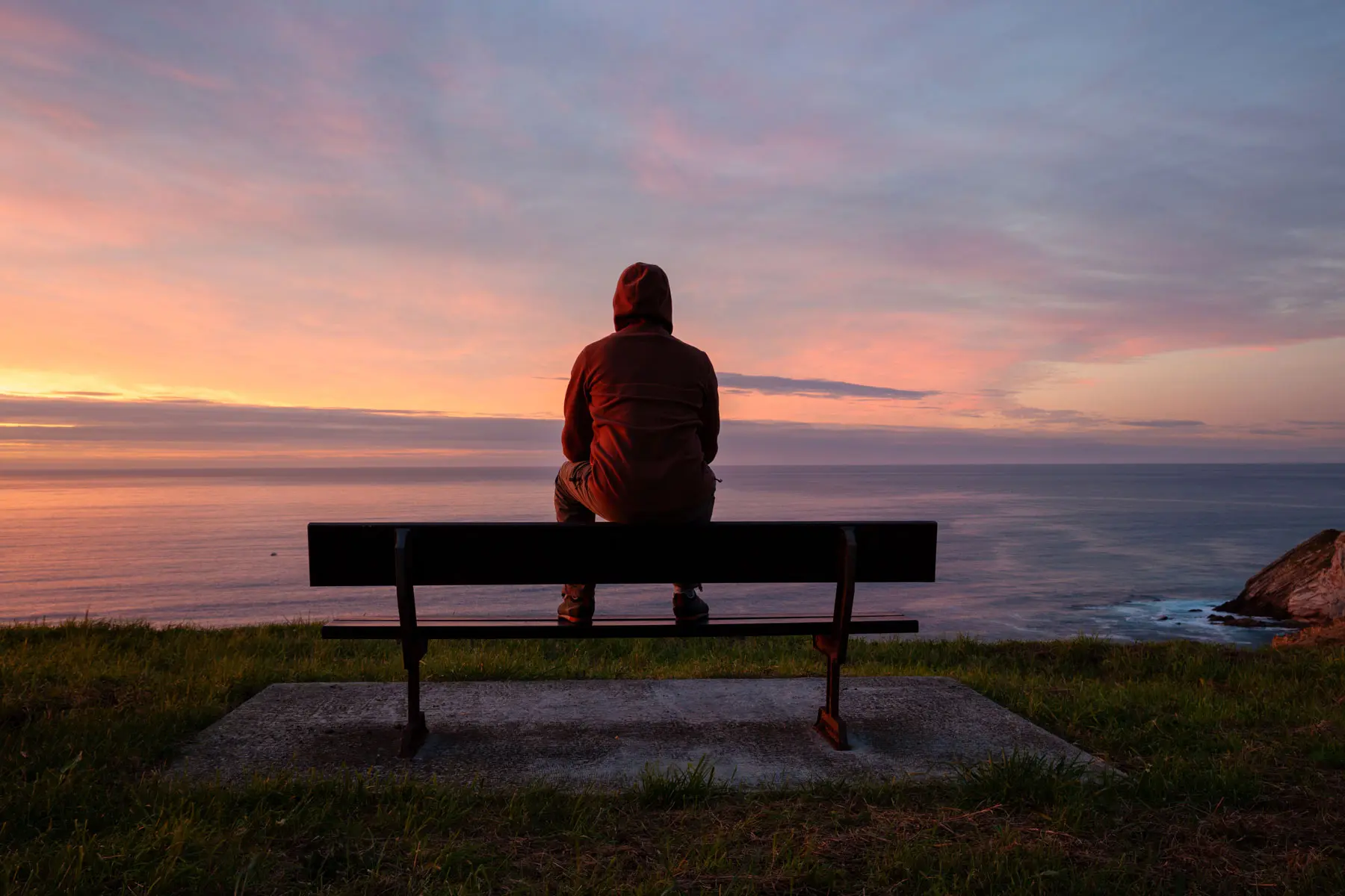 How the Epidemic of Loneliness is Impacting Mental Health a man feels lonely to the point of it affecting his mental health as he sits alone on a bench at dusk