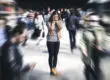 a woman struggles to manage a trauma response in a large crowd
