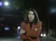 a woman struggles to calm her anxiety symptoms as she walks at night
