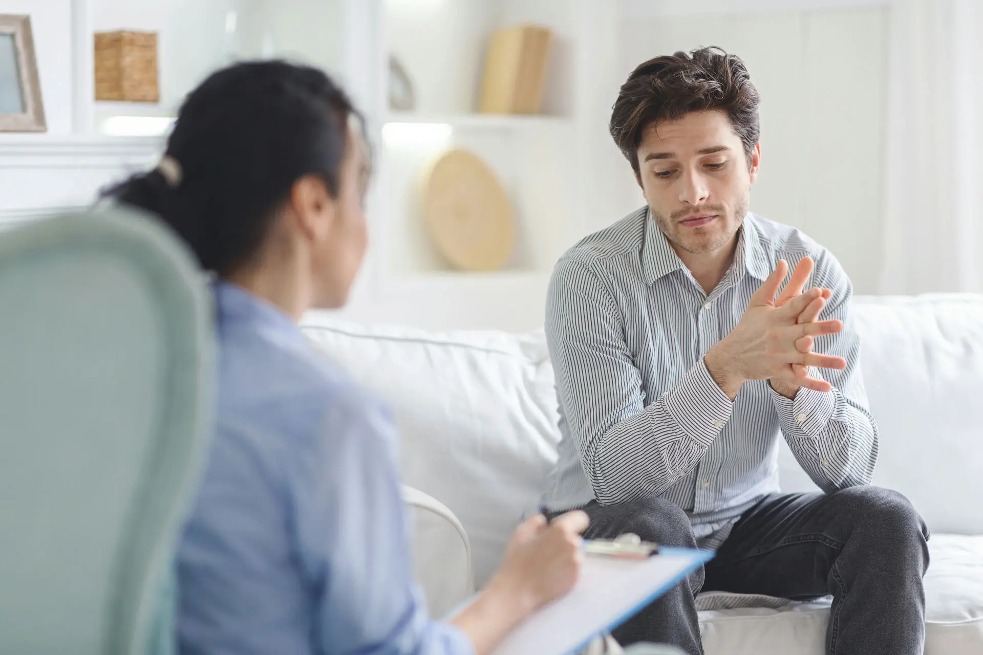 Therapist guiding client through Rational Emotive Behavior Therapy (REBT) session in Florida to challenge irrational beliefs and improve mental health.