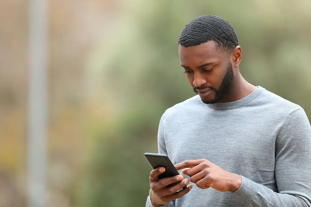 Man using his phone to call a trusted friend.