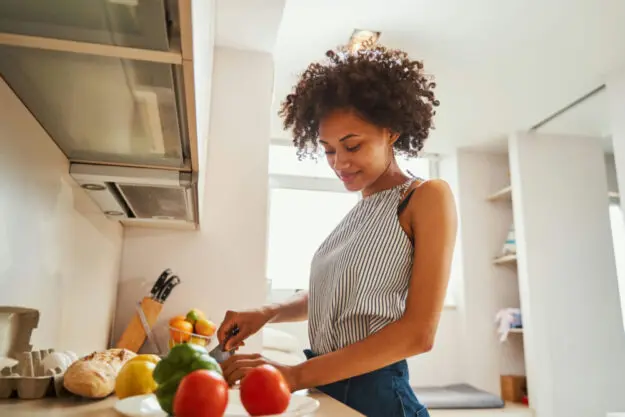 woman preparing a balanced meal to support brain health and emotional well-being