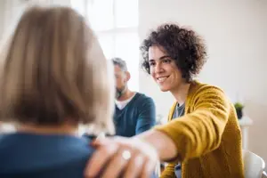 a group of people talk during a group therapy program