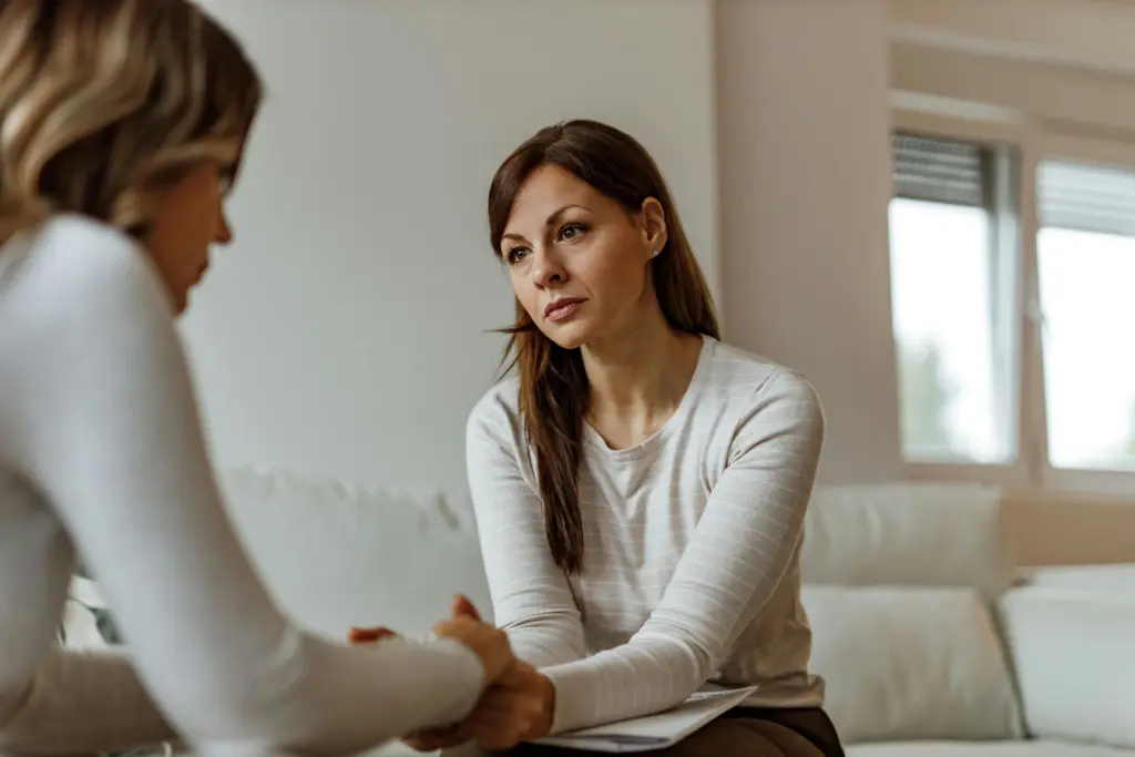 Person offering support while talking to someone who self-harms in a calm setting