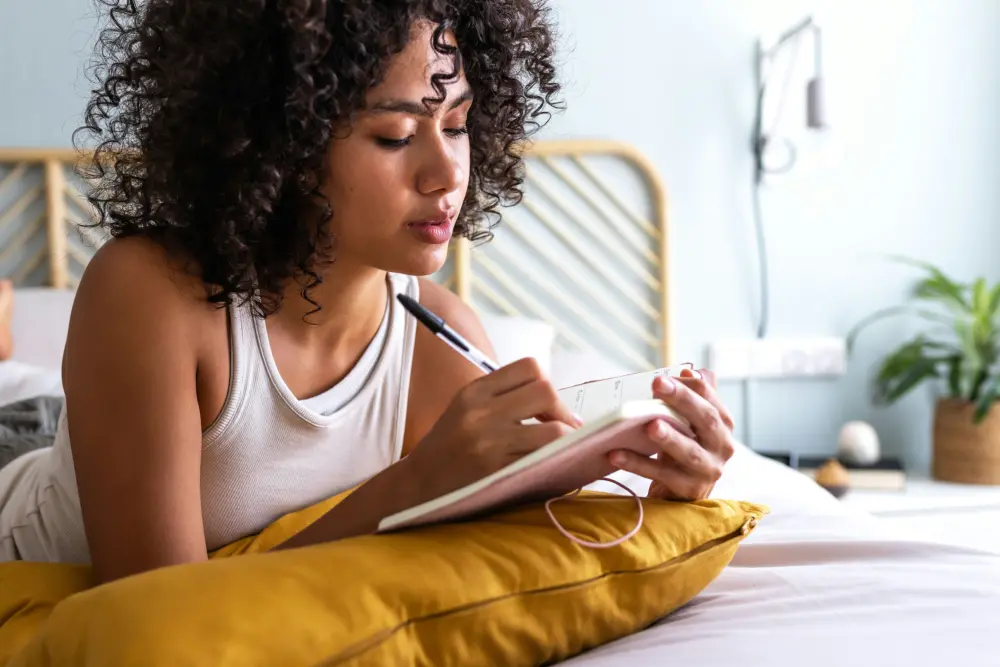 woman creating a recovery action plan and identifying personal goals for long-term success.