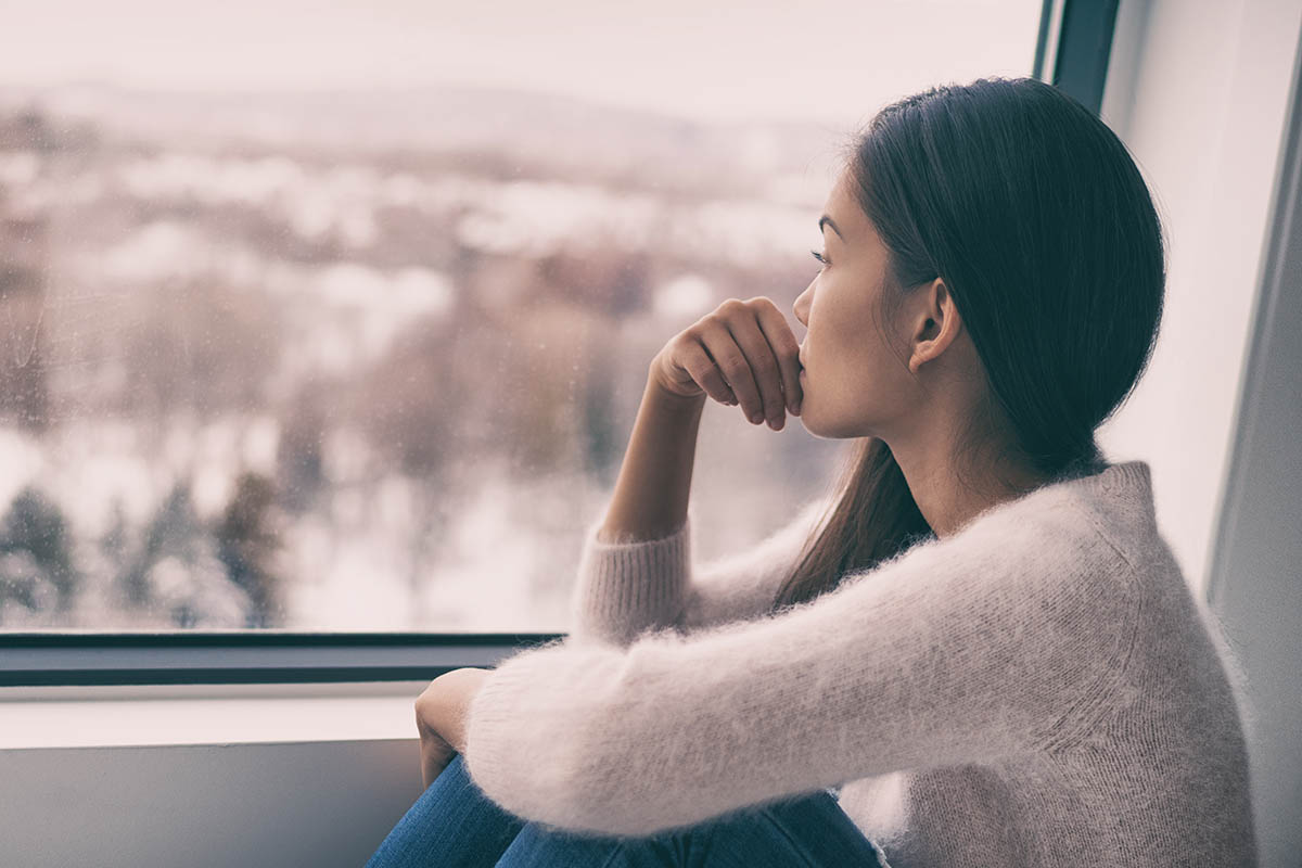 woman showing how to take care of your mental health this winter