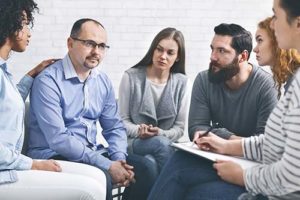 individual in group therapy at Kratom Addiction Treatment Program