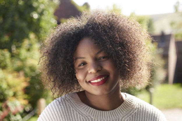 a woman smiles because she has mental health awareness