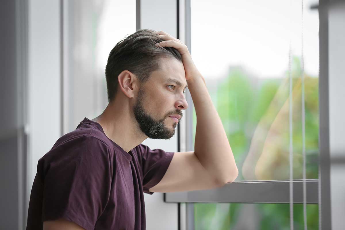 a man ponders a mental health treatment program