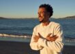 a man walks on the beach at dusk feeling confident in his relapse prevention plan