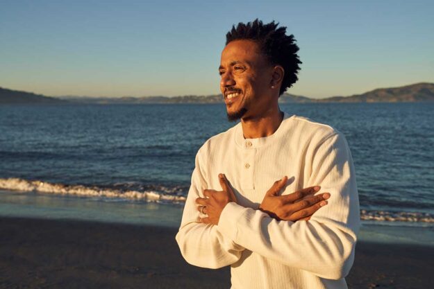 a man walks on the beach at dusk feeling confident in his relapse prevention plan