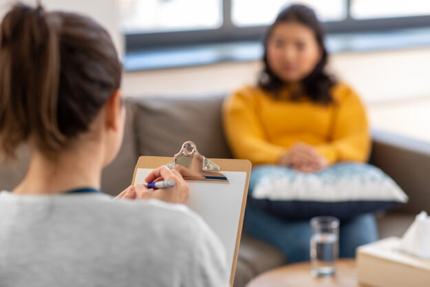 a patient talks to a therapist during manic depression treatment