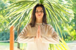 woman with folded hands in Mindfulness Meditation Therapy