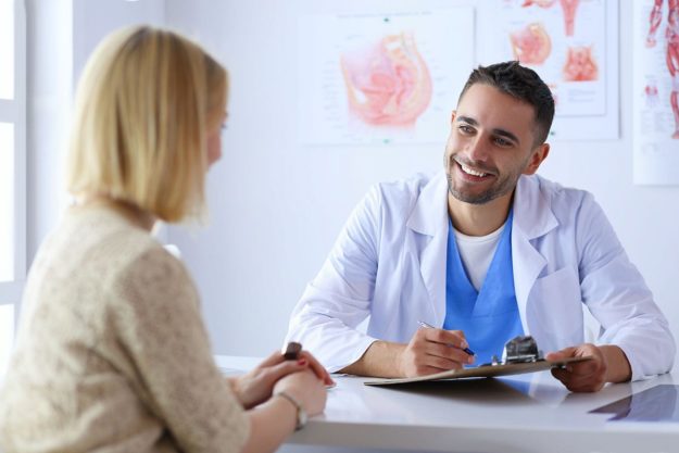 a woman talking to her doctor about the benefits of a medication management program