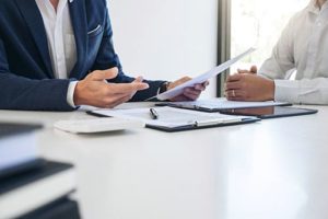 two people looking over bright healthcare forms to pay for treatment