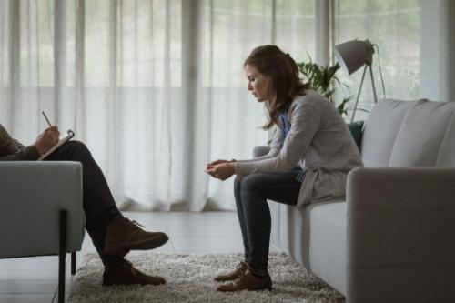 a woman talks to a therapist at an anxiety treatment program in florida