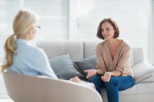 a woman talks to a therapist about mental health treatment programs in florida 
