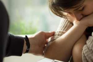 a young woman is comforted in a self harm treatment program in florida 