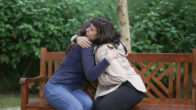 Two people hugging and learning how to talk about depression