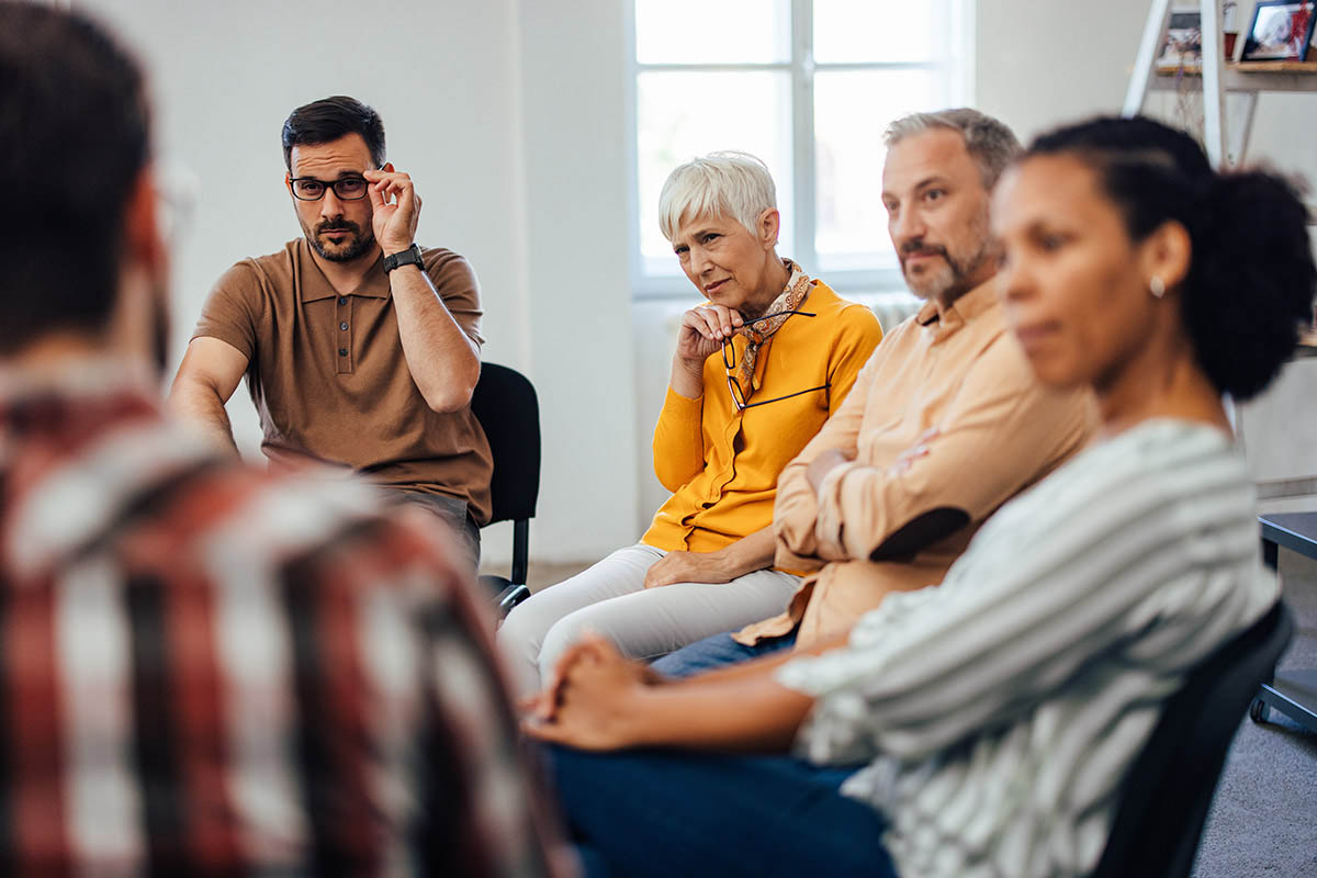 a group of people participate in group therapy activities for adults