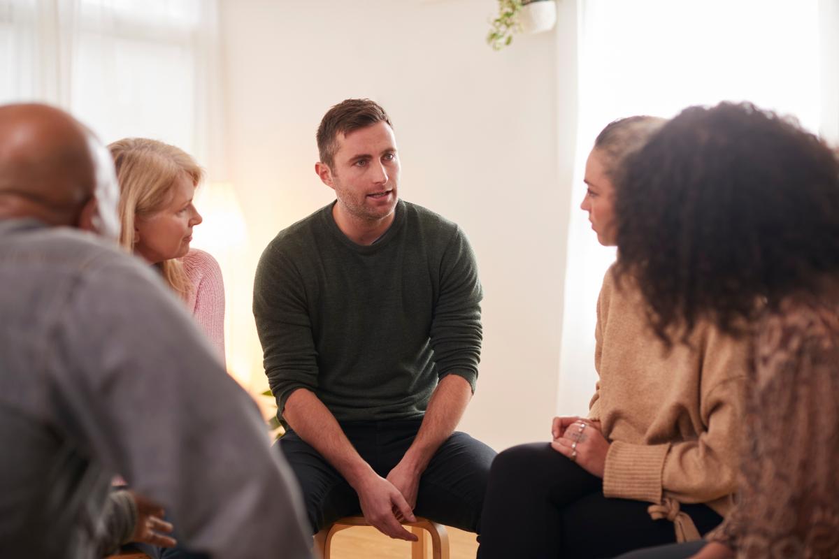 a man finds the support he needed in group therapy as part of an iop for mental health treatment in florida