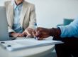 an advisor goes over insurance coverage with a person looking for help paying for mental health treatment