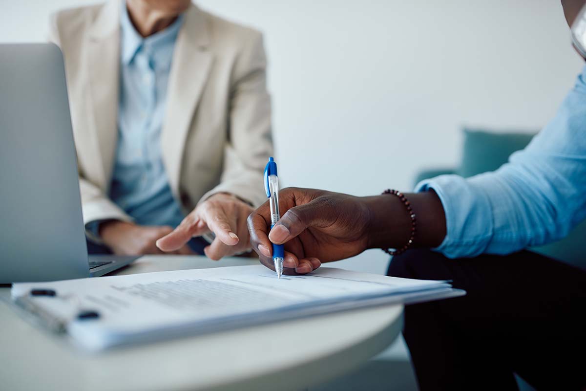 an advisor goes over insurance coverage with a person looking for help paying for mental health treatment