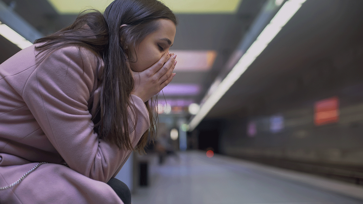 a woman struggles to manage the symptoms of her anxiety while traveling