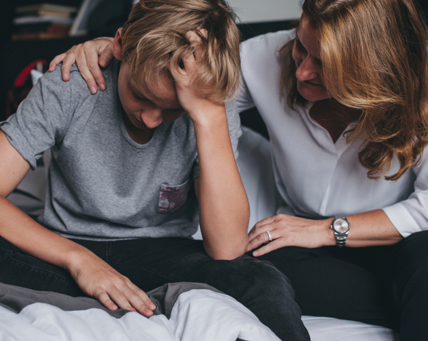 a younger person is comforted by an older person to show guardianship for schizophrenia