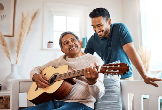 a person plays guitar while their sibling stands above and smiles to show guardianship of an incapacitated adult