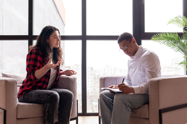 a patient in a flannel talks to a doctor about treatment options for schizophrenia