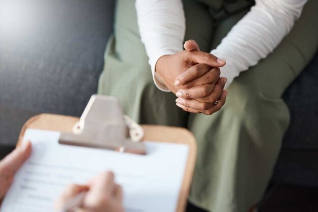a woman meets with a professional for a depression diagnosis