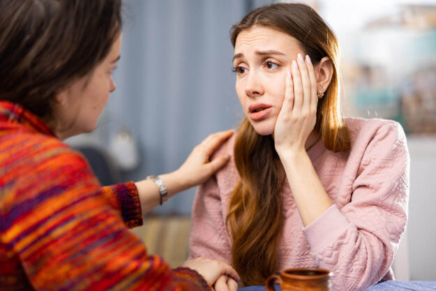 a person looks sad at a friend to show they need a suicide treatment center