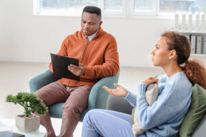 a therapist talks to a patient in an individual therapy program