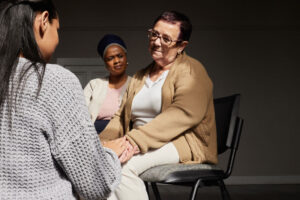 three people talk at a suicide treatment center