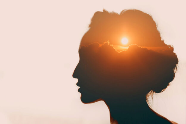 artistic rendering of the sun setting in the mind of a woman