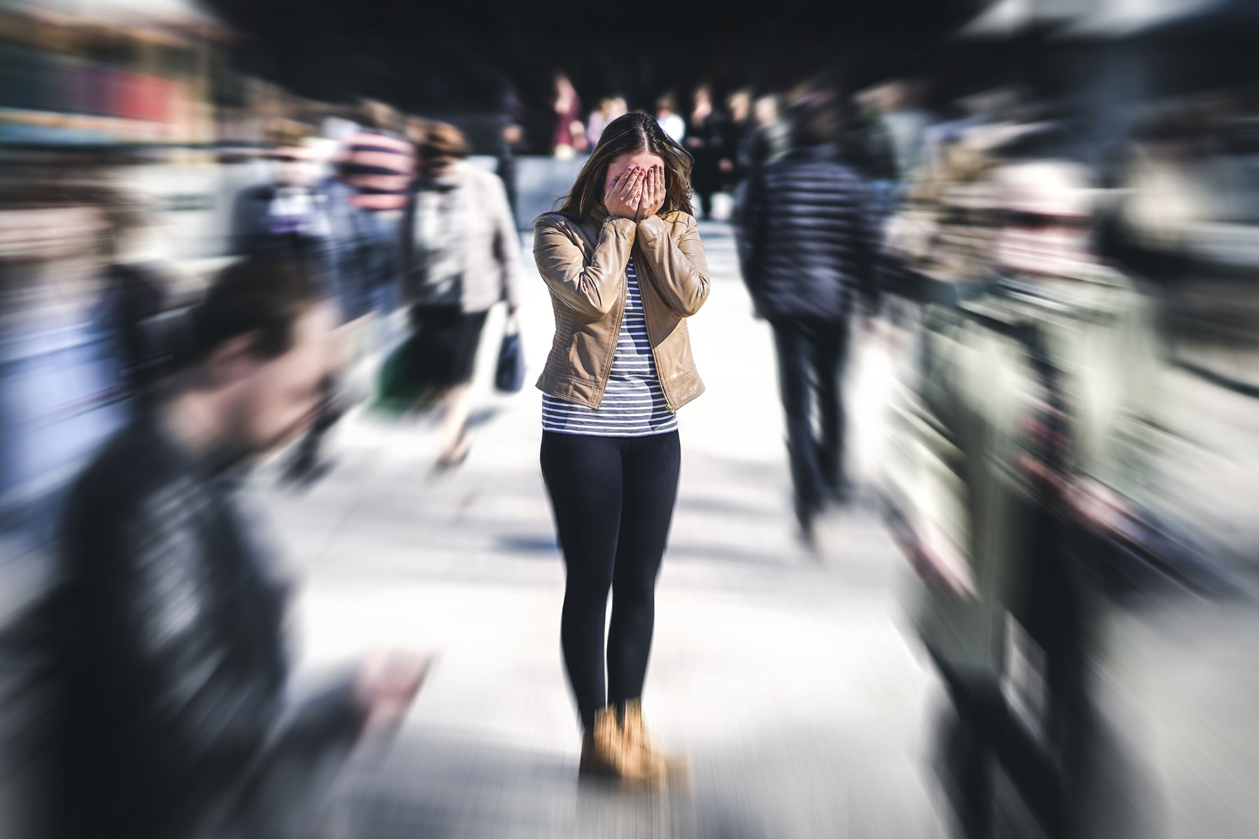 a woman struggles to manage a trauma response in a large crowd