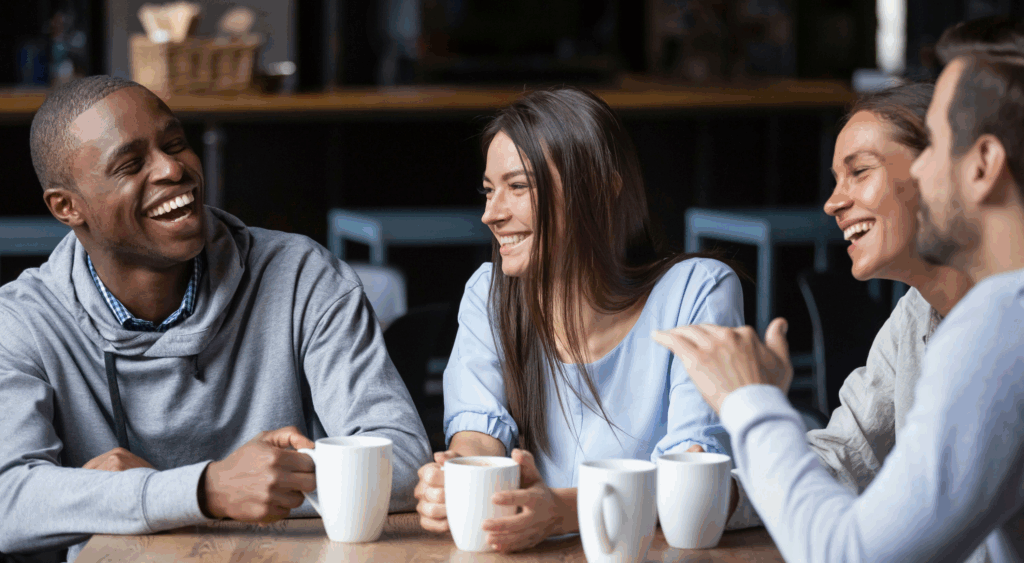happy group in recovery from depression and addiction, meeting for coffee