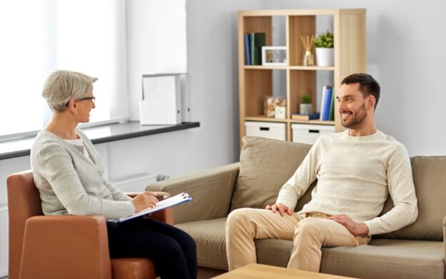 man practicing calming breathing exercises during therapy session for panic attack treatment at Harmony Hills