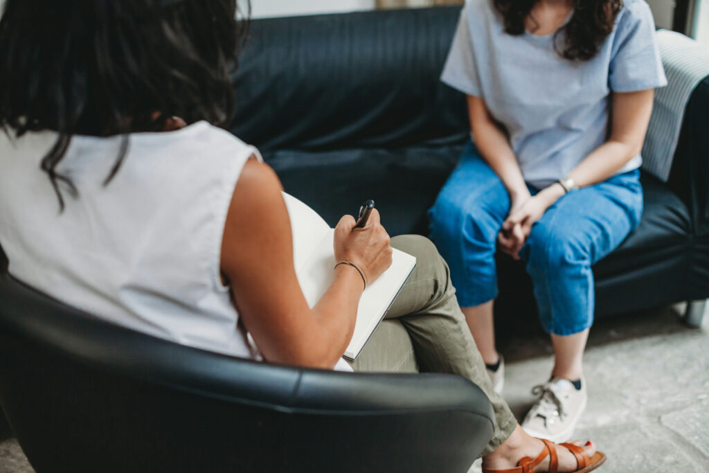 Therapist speaking with a client in a supportive counseling session, representing mental health therapy in Florida.