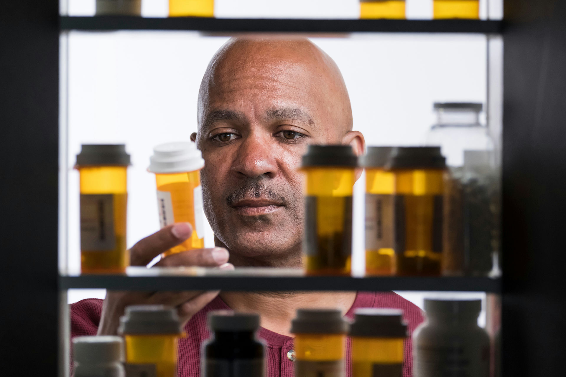 Adult reviewing a prescription muscle relaxer bottle while researching medication safety.
