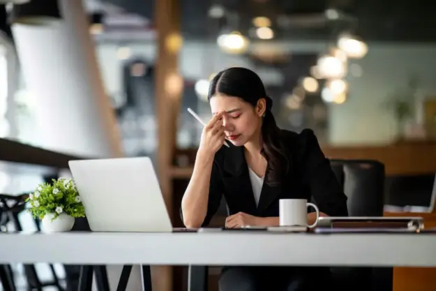professional experiencing exhaustion while learning how to recover from burnout and manage stress.