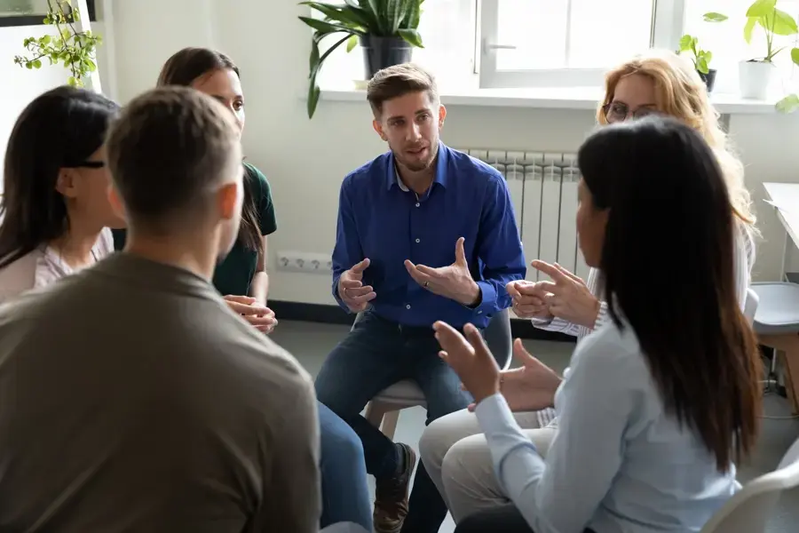 group therapy participants supporting each other at a PTSD treatment center in Florida