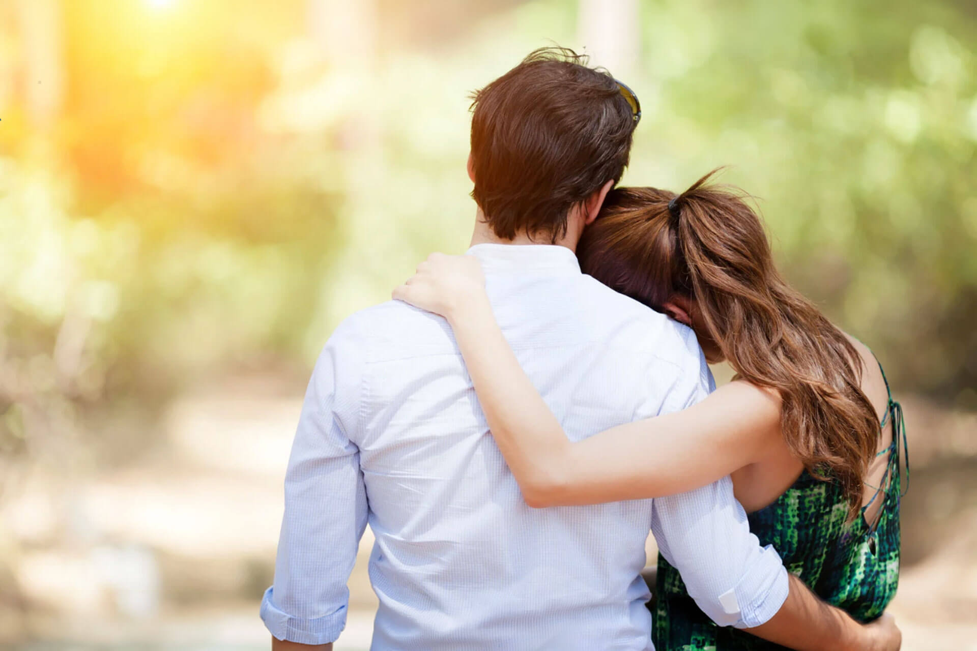 when-a-mental-health-diagnosis-comes-with-a-substance-use-problem-what-families-should-know A woman rests her head on a man's shoulder as they embrace and face a sunlit, blurred background.